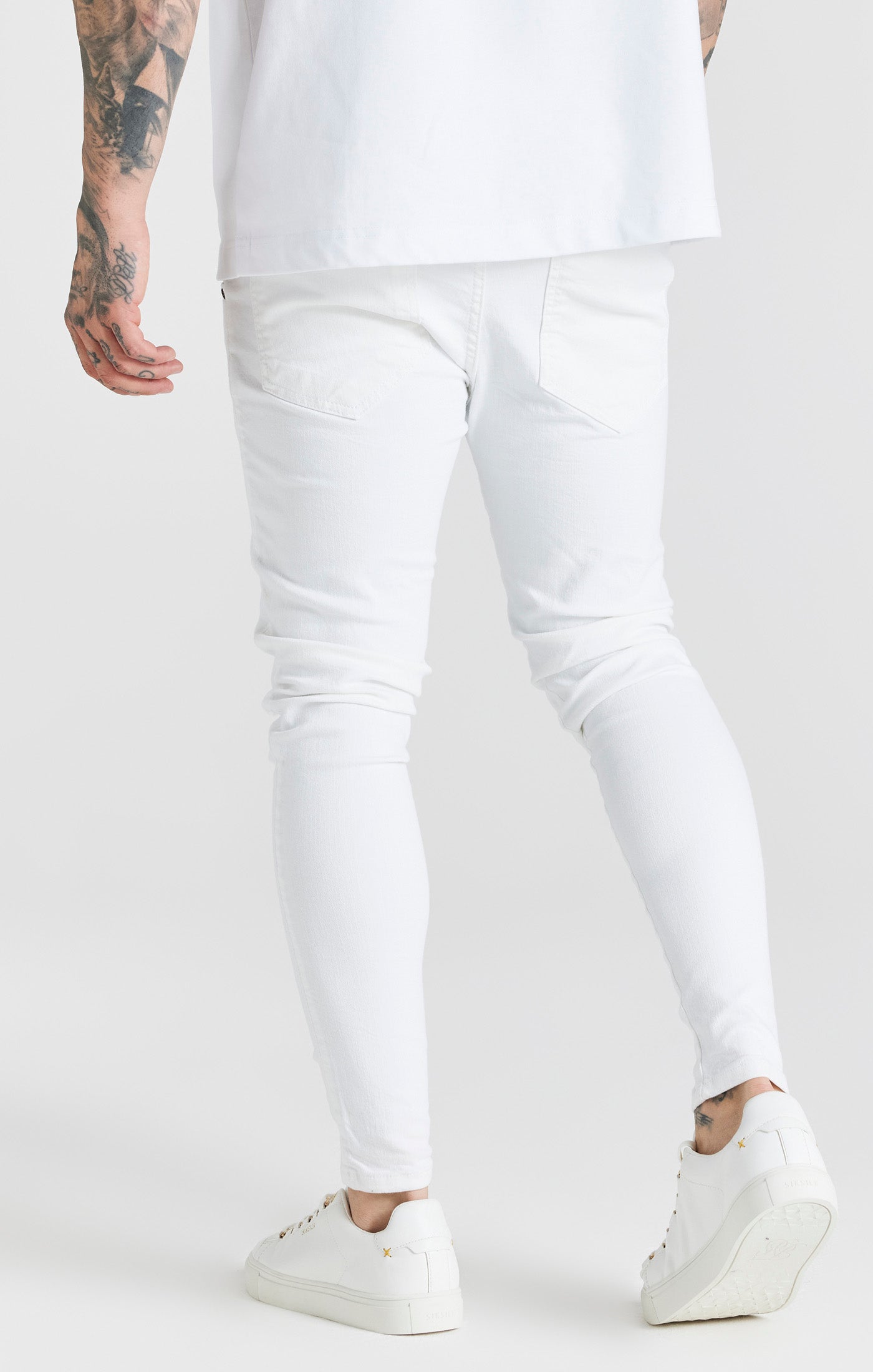 Laad de afbeelding in de Galerij viewer, Essentials - Wit verwassen skinny jeans met een gedragen look en versleten details (3)