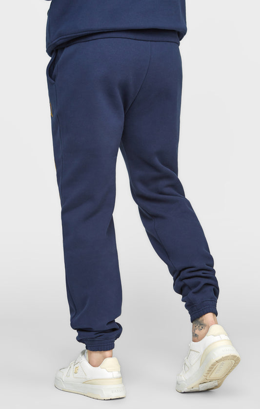 Marineblauwe joggingbroek met losse pasvorm (relaxed fit) en borduursel