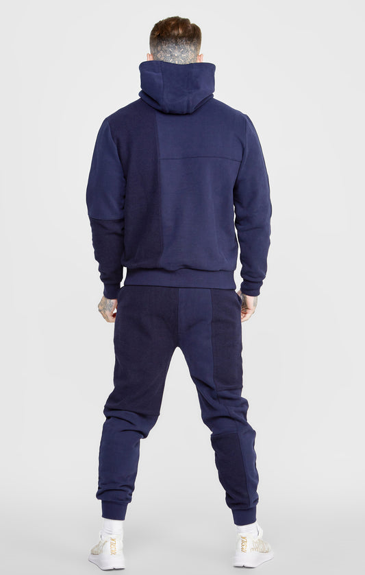 Marineblauwe oversized sweater met capuchon, knip- en naaitechniek en omgekeerde stof